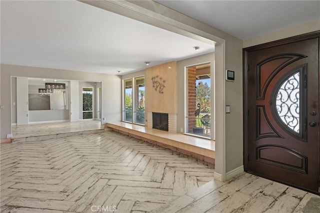 618 E Sunset Dr N, Redlands, CA 92373 - foyer entrance featuring a chandelier, plenty of natural light, and a fireplace