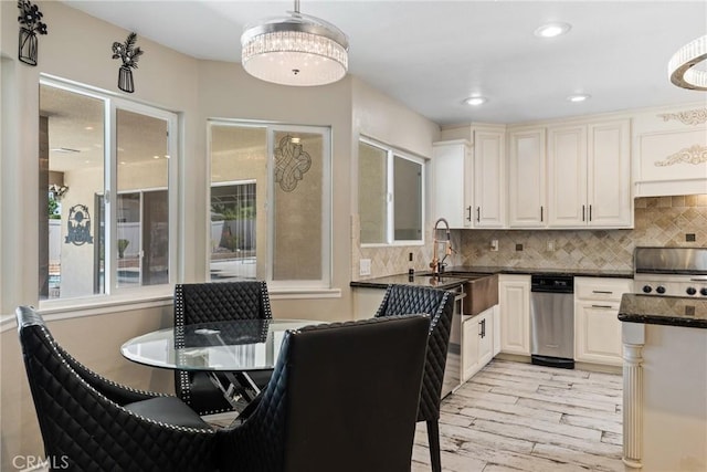 618 E Sunset Dr N, Redlands, CA 92373 - kitchen with light wood-style floors, decorative backsplash, dark stone counters, decorative light fixtures, and recessed lighting