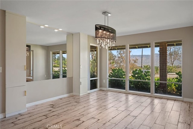 618 E Sunset Dr N, Redlands, CA 92373 - unfurnished room featuring recessed lighting, wood finished floors, and a chandelier