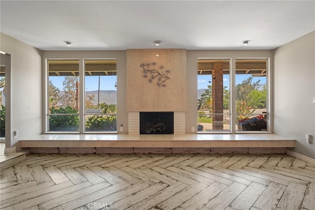618 E Sunset Dr N, Redlands, CA 92373 - unfurnished living room with a fireplace and baseboards