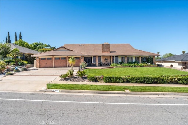 618 E Sunset Dr N, Redlands, CA 92373 - ranch-style home featuring a front lawn, an attached garage, concrete driveway, and a tiled roof
