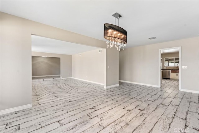 618 E Sunset Dr N, Redlands, CA 92373 - spare room with a chandelier and light wood-type flooring