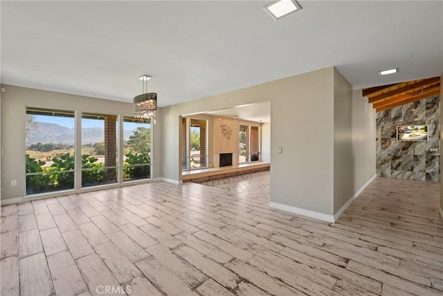618 E Sunset Dr N, Redlands, CA 92373 - unfurnished living room featuring wood finished floors and a chandelier