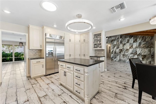 618 E Sunset Dr N, Redlands, CA 92373 - kitchen featuring built in refrigerator, a center island, tasteful backsplash, recessed lighting, and dark stone counters