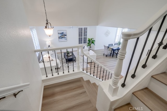 2115 Via Viejo, San Clemente, CA 92673 - stairs featuring wood finished floors, a high ceiling, and a textured wall