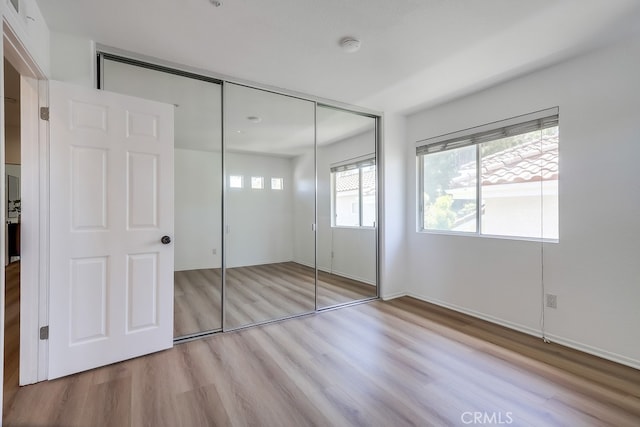 2115 Via Viejo, San Clemente, CA 92673 - unfurnished bedroom with wood finished floors, a closet, and baseboards