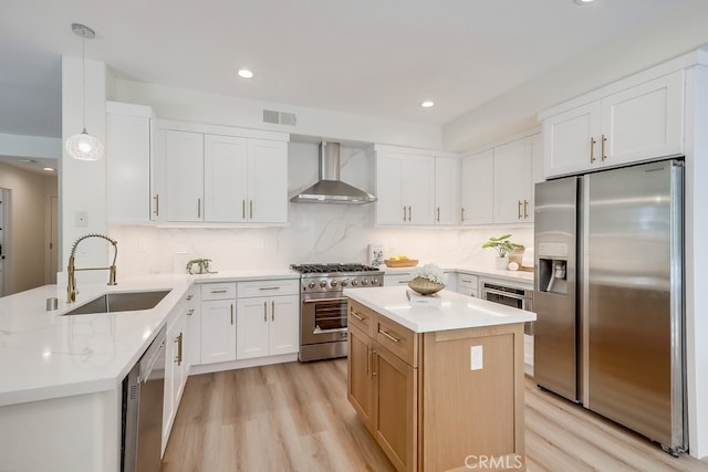 2115 Via Viejo, San Clemente, CA 92673 - kitchen featuring appliances with stainless steel finishes, wall chimney range hood, a sink, light wood finished floors, and recessed lighting
