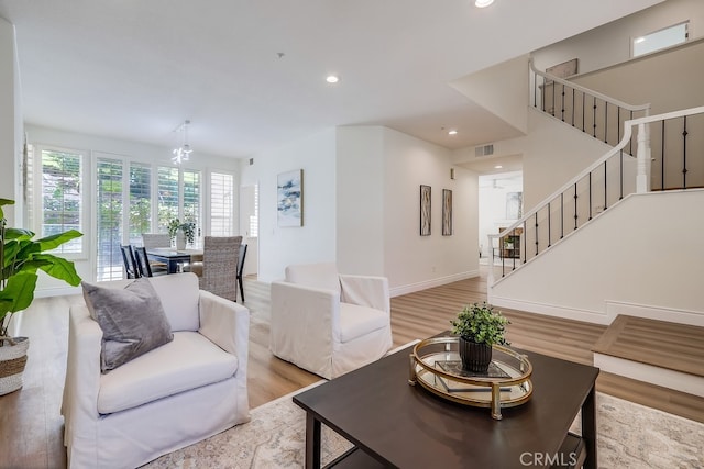 2115 Via Viejo, San Clemente, CA 92673 - living area featuring stairway, light wood finished floors, a chandelier, recessed lighting, and baseboards