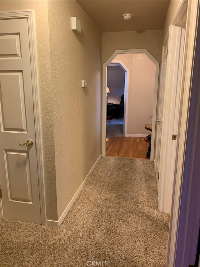 18427 Deer Hl, Hidden Valley Lake, CA 95467 - hallway featuring carpet floors, arched walkways, and a textured wall