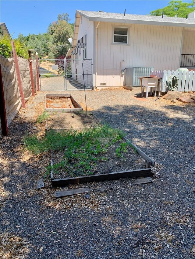 18427 Deer Hl, Hidden Valley Lake, CA 95467 - view of property exterior with a garden, crawl space, and a gate