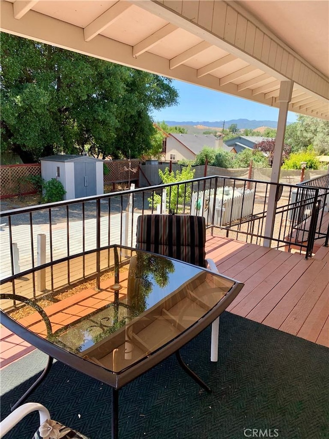 18427 Deer Hl, Hidden Valley Lake, CA 95467 - deck featuring a shed, outdoor dining space, and a fenced backyard