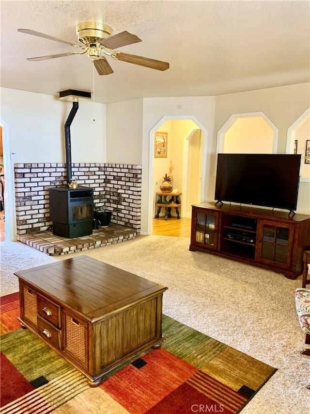 18427 Deer Hl, Hidden Valley Lake, CA 95467 - carpeted living area featuring ceiling fan, a wood stove, and arched walkways
