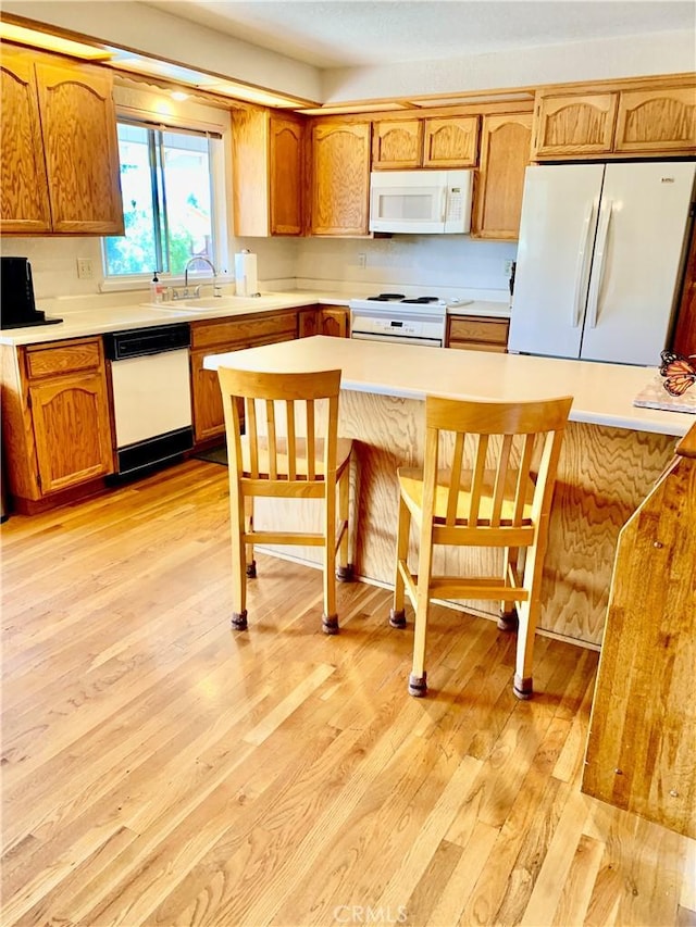 18427 Deer Hl, Hidden Valley Lake, CA 95467 - kitchen featuring white appliances, light wood-style flooring, and light countertops
