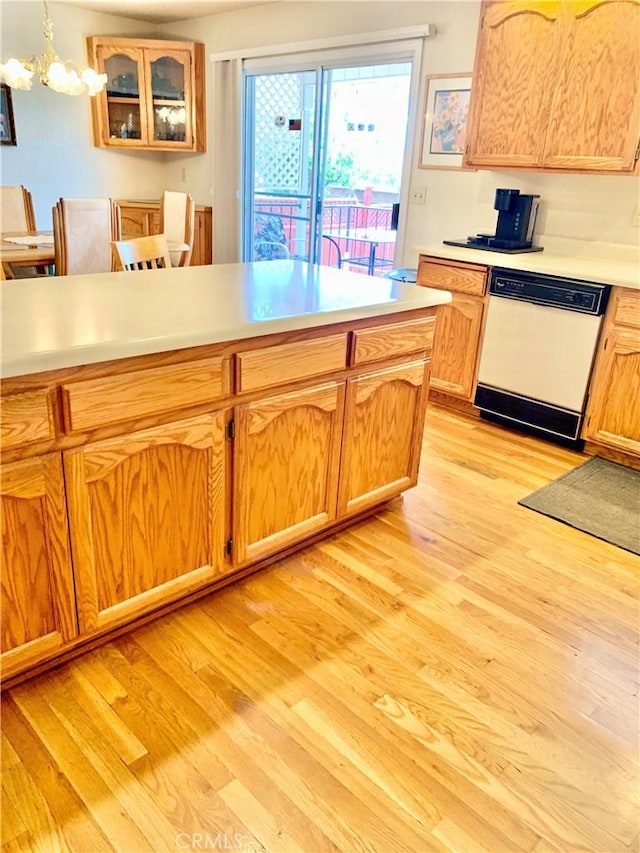 18427 Deer Hl, Hidden Valley Lake, CA 95467 - kitchen with dishwasher, a chandelier, light countertops, light wood finished floors, and glass insert cabinets