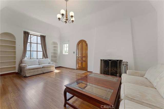 1194 Avoca Ave, Pasadena, CA 91105 - living area with built in features, a chandelier, wood finished floors, and a large fireplace