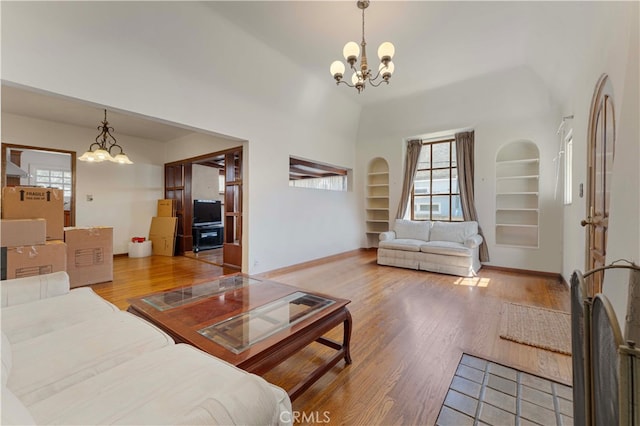 1194 Avoca Ave, Pasadena, CA 91105 - living area with a chandelier, built in shelves, healthy amount of natural light, wood finished floors, and a towering ceiling