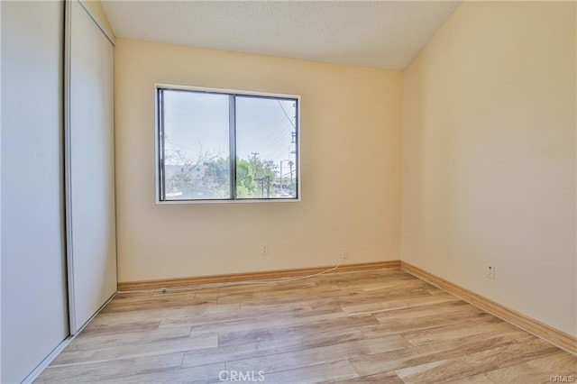 spare room with light wood-type flooring