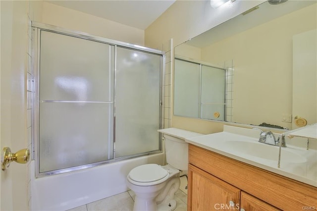 bathroom with tile patterned flooring, vanity, combined bath / shower with glass door, and toilet