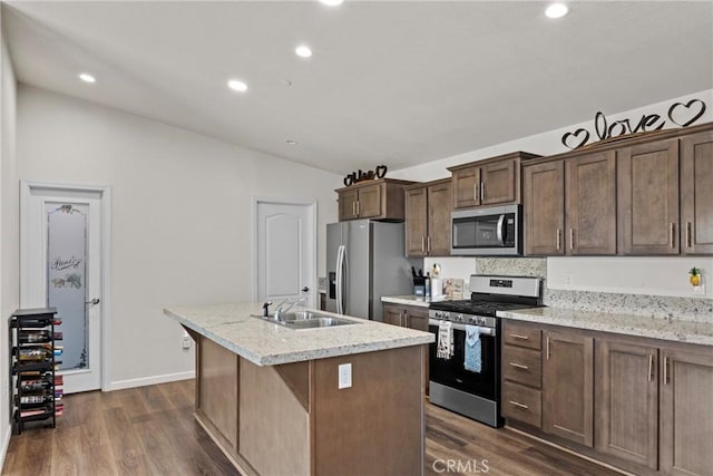2289 Kyla Ct, San Bernardino, CA 92410 - kitchen with stainless steel appliances, a sink, dark wood-style flooring, a kitchen island with sink, and recessed lighting