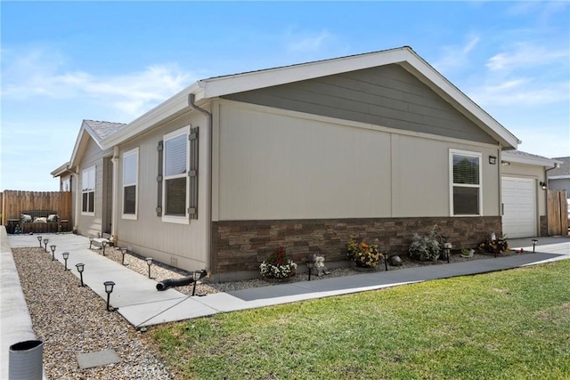 2289 Kyla Ct, San Bernardino, CA 92410 - view of home's exterior with stone siding and a garage