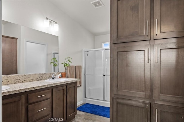 2289 Kyla Ct, San Bernardino, CA 92410 - bathroom featuring a stall shower, wood finished floors, double vanity, and lofted ceiling