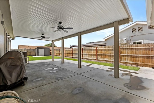 2289 Kyla Ct, San Bernardino, CA 92410 - view of patio with a storage unit, an outbuilding, a fenced backyard, and a ceiling fan