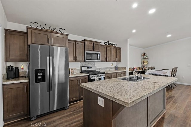 2289 Kyla Ct, San Bernardino, CA 92410 - kitchen with appliances with stainless steel finishes, a sink, dark wood-style flooring, dark brown cabinetry, and light countertops