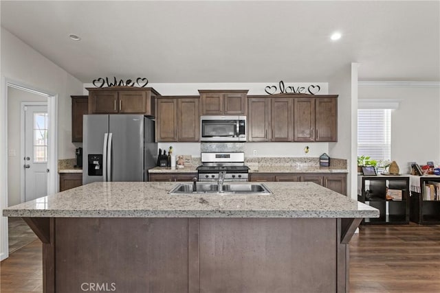 2289 Kyla Ct, San Bernardino, CA 92410 - kitchen with appliances with stainless steel finishes, dark wood-style flooring, a sink, dark brown cabinetry, and plenty of natural light