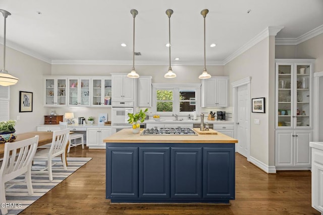 260 W Carter Ave, Sierra Madre, CA 91024 - kitchen featuring blue cabinets, a kitchen island, white cabinets, double oven, and crown molding
