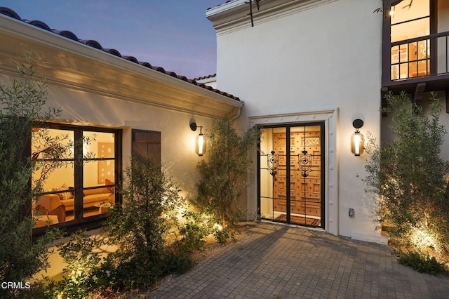 620 S Allen Ave, San Marino, CA 91108 - exterior entry at dusk with stucco siding and french doors
