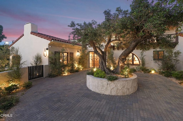 620 S Allen Ave, San Marino, CA 91108 - mediterranean / spanish house featuring a chimney, stucco siding, a tiled roof, and a gate