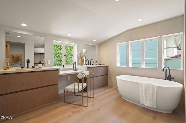 620 S Allen Ave, San Marino, CA 91108 - bathroom featuring wood finished floors, two vanities, a freestanding tub, recessed lighting, and lofted ceiling