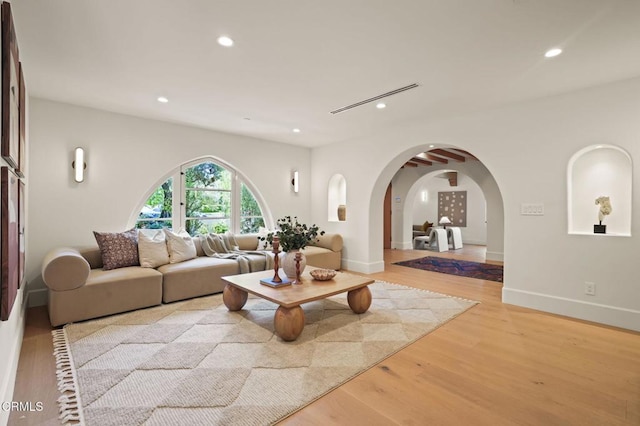 620 S Allen Ave, San Marino, CA 91108 - living room featuring arched walkways, recessed lighting, light wood-style floors, and baseboards