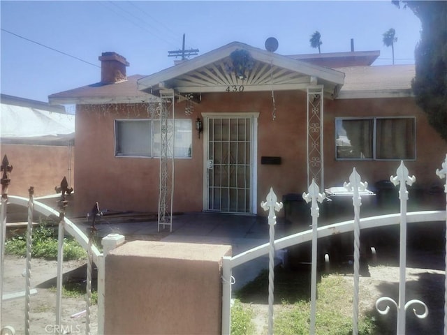back of house featuring stucco siding and a patio