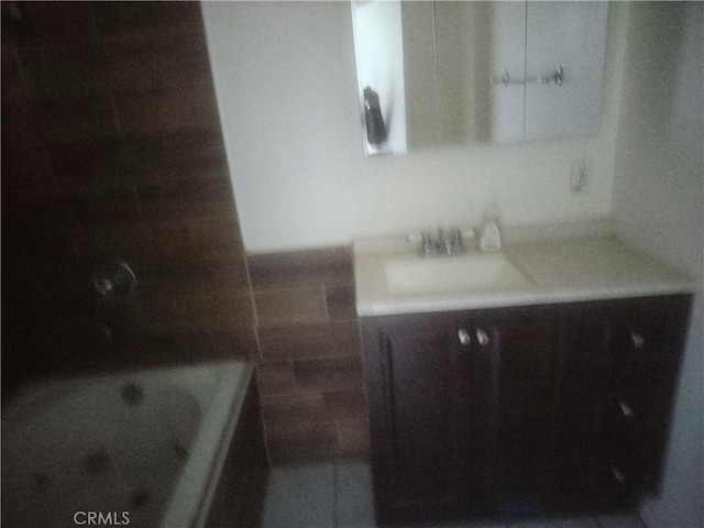 bathroom with vanity, a bathtub, and tile walls