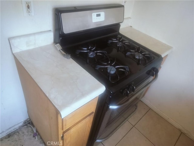 detailed view of stainless steel gas stove and baseboards