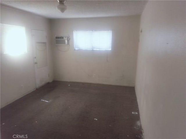 empty room featuring an AC wall unit