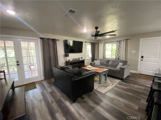 living room featuring a ceiling fan, dark wood-type flooring, french doors, baseboards, and a textured ceiling