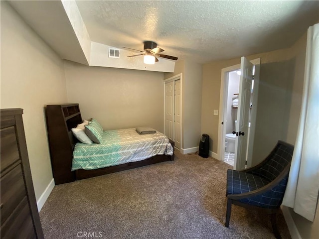 carpeted bedroom with a textured ceiling, a closet, baseboards, and a ceiling fan