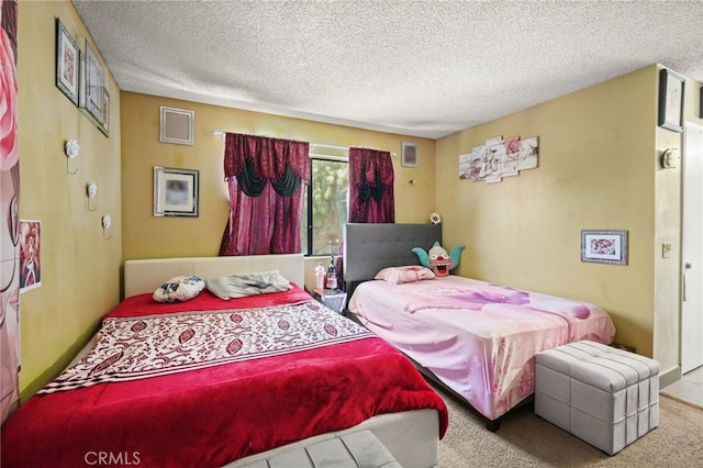 bedroom with carpet and a textured ceiling