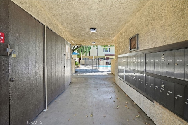 view of patio / terrace featuring mail area and fence