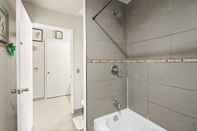 bathroom with tile patterned floors, bathtub / shower combination, and baseboards