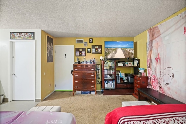 carpeted bedroom with a textured ceiling and baseboards