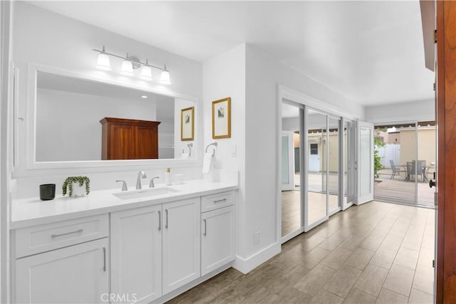 5314 E 4th St, Long Beach, CA 90814 - bathroom featuring wood finished floors, vanity, and baseboards
