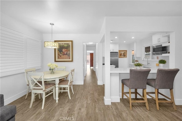 5314 E 4th St, Long Beach, CA 90814 - dining space with baseboards, light wood-style floors, and recessed lighting