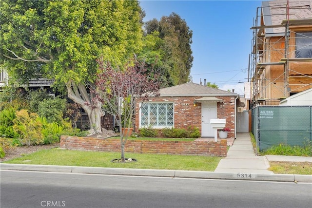 5314 E 4th St, Long Beach, CA 90814 - view of front of house featuring fence, brick siding, and roof with shingles