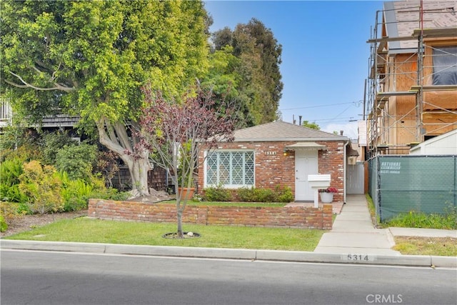 5314 E 4th St, Long Beach, CA 90814 - obstructed view of property with a shingled roof and brick siding