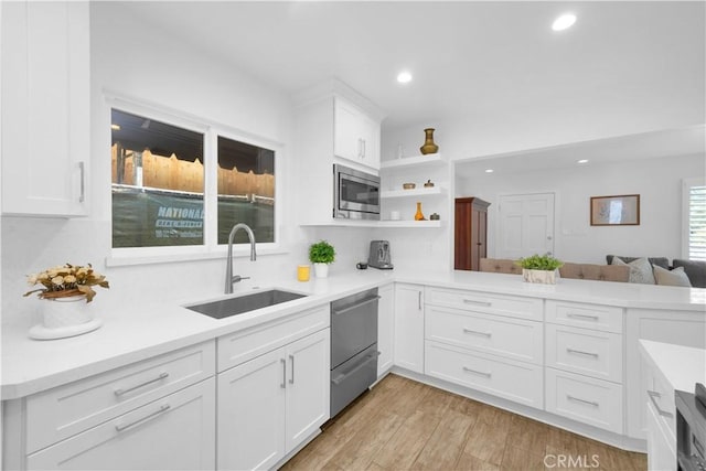5314 E 4th St, Long Beach, CA 90814 - kitchen with appliances with stainless steel finishes, a sink, recessed lighting, light countertops, and white cabinetry