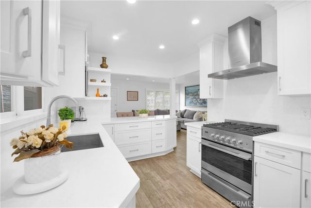 5314 E 4th St, Long Beach, CA 90814 - kitchen featuring wall chimney range hood, stainless steel gas range, a sink, open shelves, and a peninsula