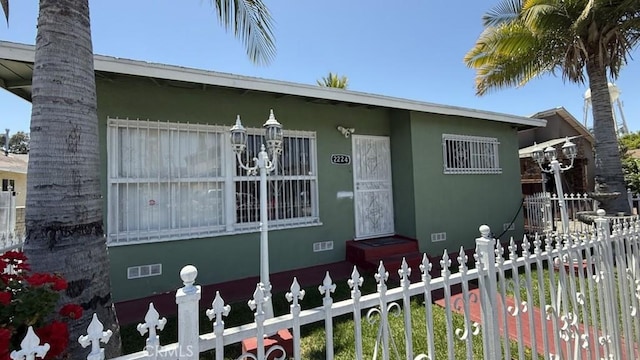 2224 Mortimer St, Huntington Park, CA 90255 - view of front of home with fence and stucco siding